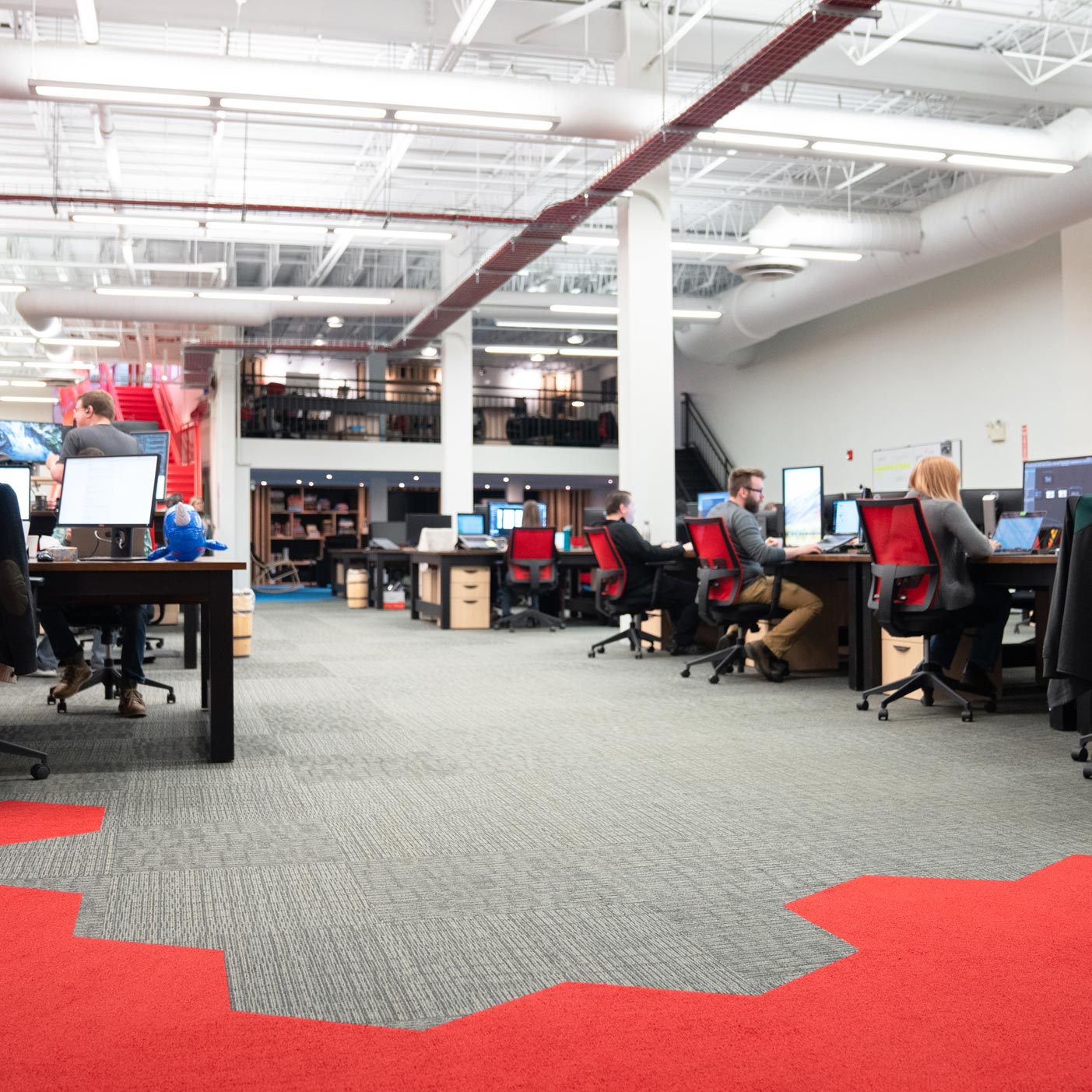 A modern office with people working on computers.