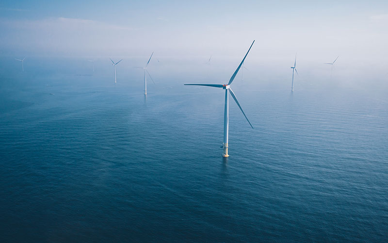 An aerial view of a large ocean wind farm.