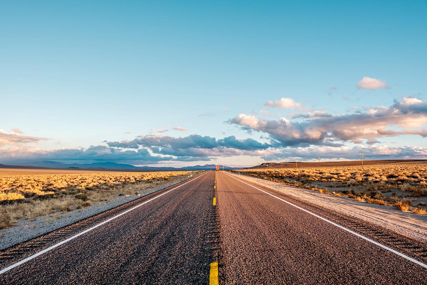 An open highway heads towards the horizon.